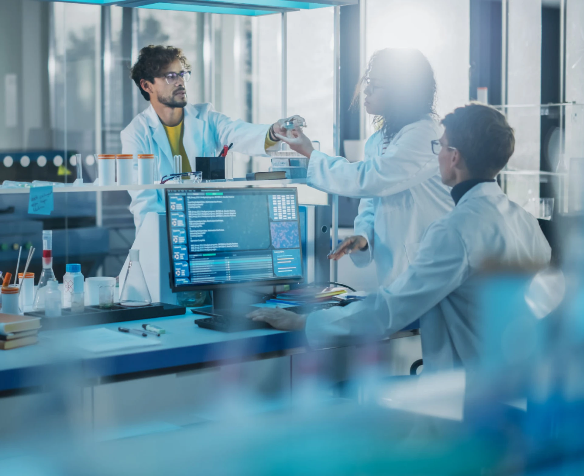 Researchers discussing data on computer screen
